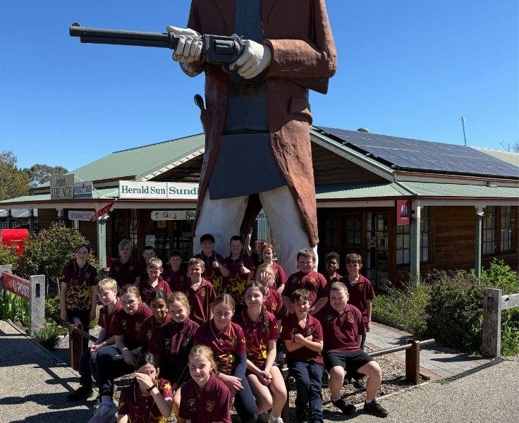 Students in front of a giant Ned Kelly statue in Glenrowan