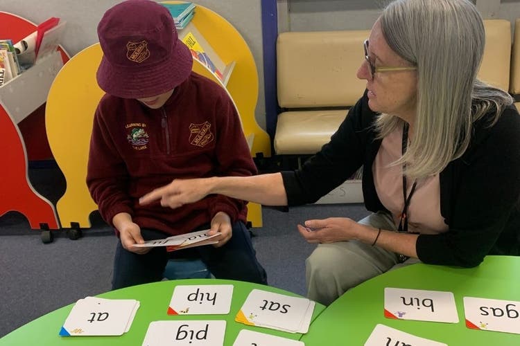 SLSO assisting a student with needs