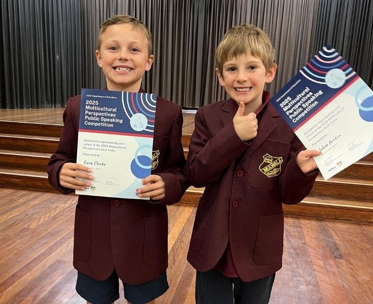 Students showing their public speaking certificates