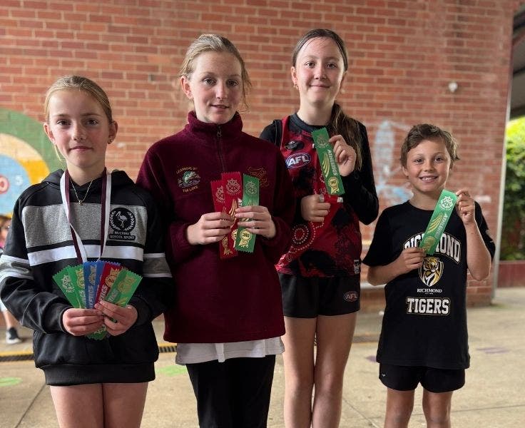 Students with medals and ribbons from the zone athletics carnival